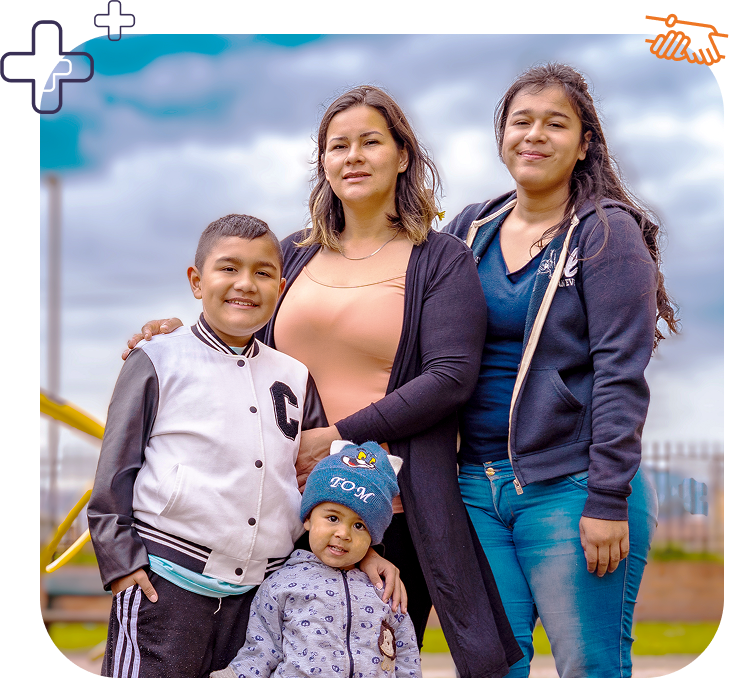 Two young boys standing with older sister and mother